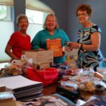 Salado Area RW members, Ann Moore, Kate McKinley and Barclay McCort prepare care packages for deployed Ft. Hood soldiers on July 13, 2017